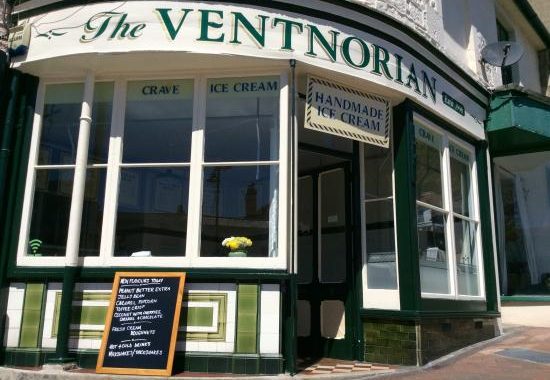 A shop frontage of an ice cream parlour on the Isle of Wight. It has a traditional look and a blackboard with specials outside.