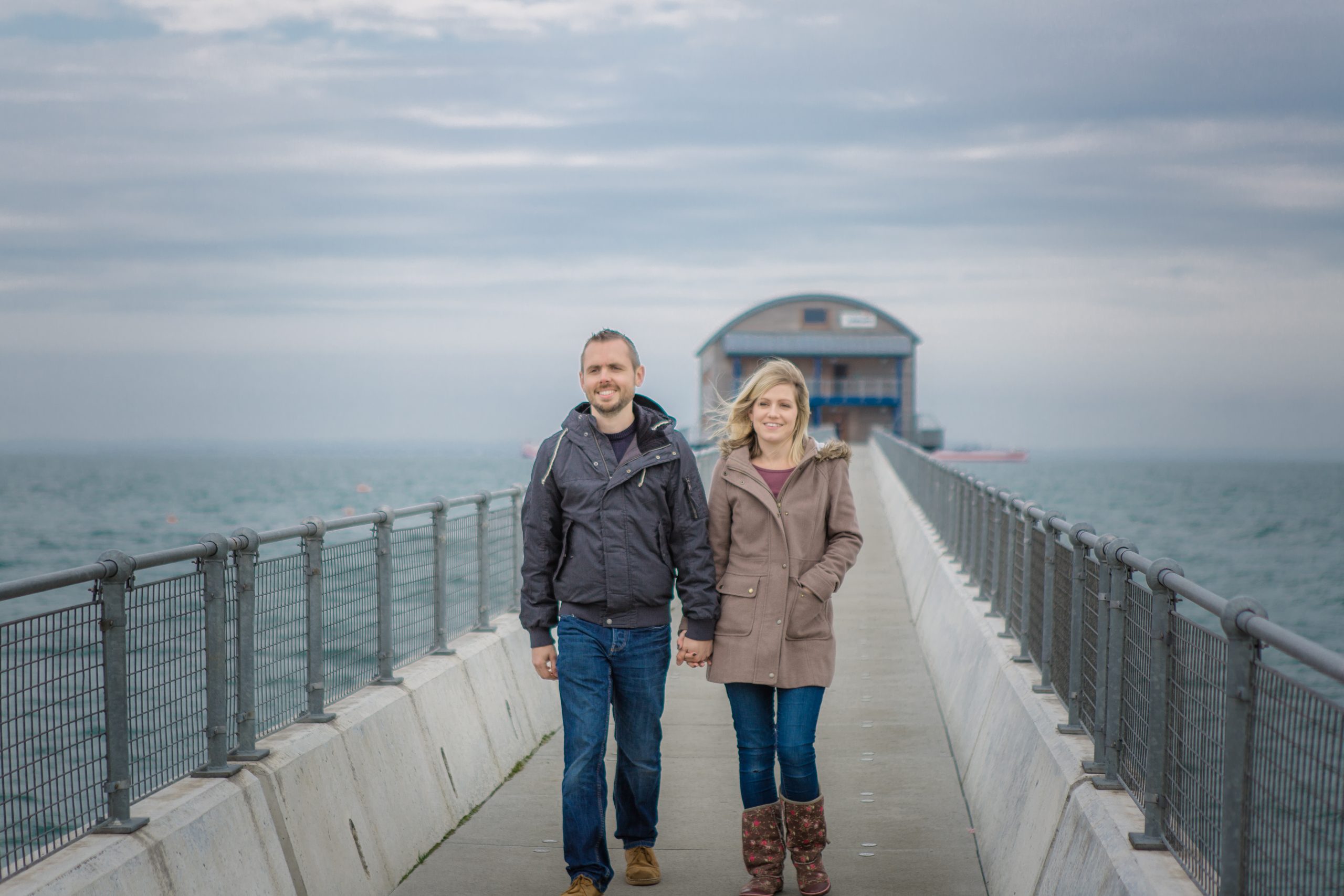 A couple walking along a pier on the Isle of Wight