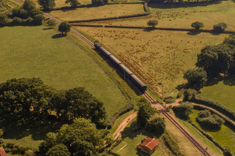 A steam train passing through the countryside on the Isle of Wight