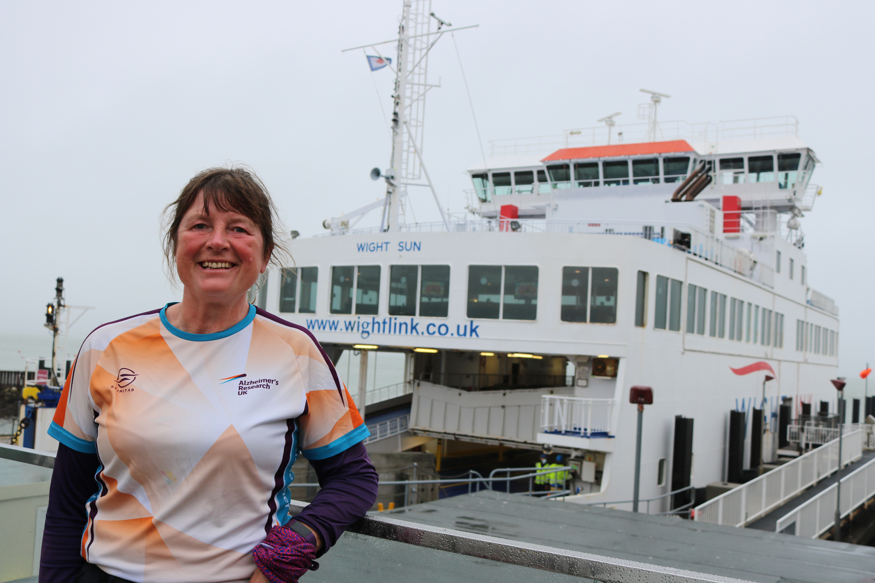 Walker Karen Penny in front of a Wightlink ferry inYarmouth