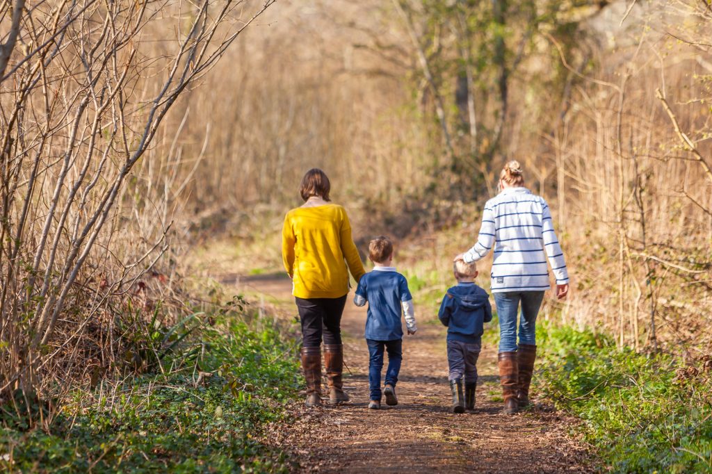 A family walking through woodland on the Isle of Wight