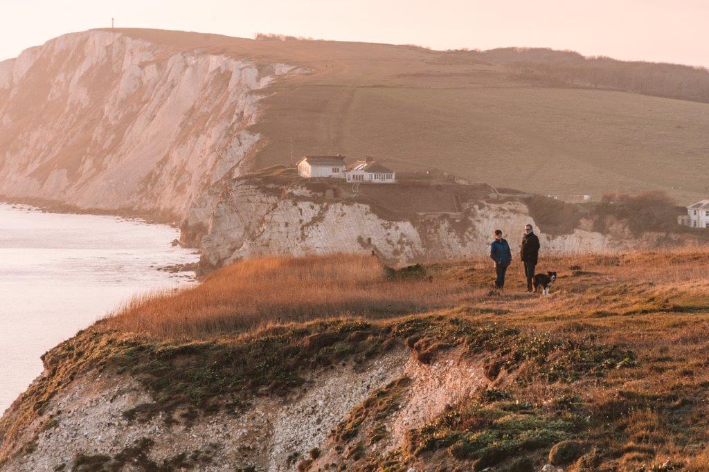 A couple walking on a coastal location on the Isle of Wight