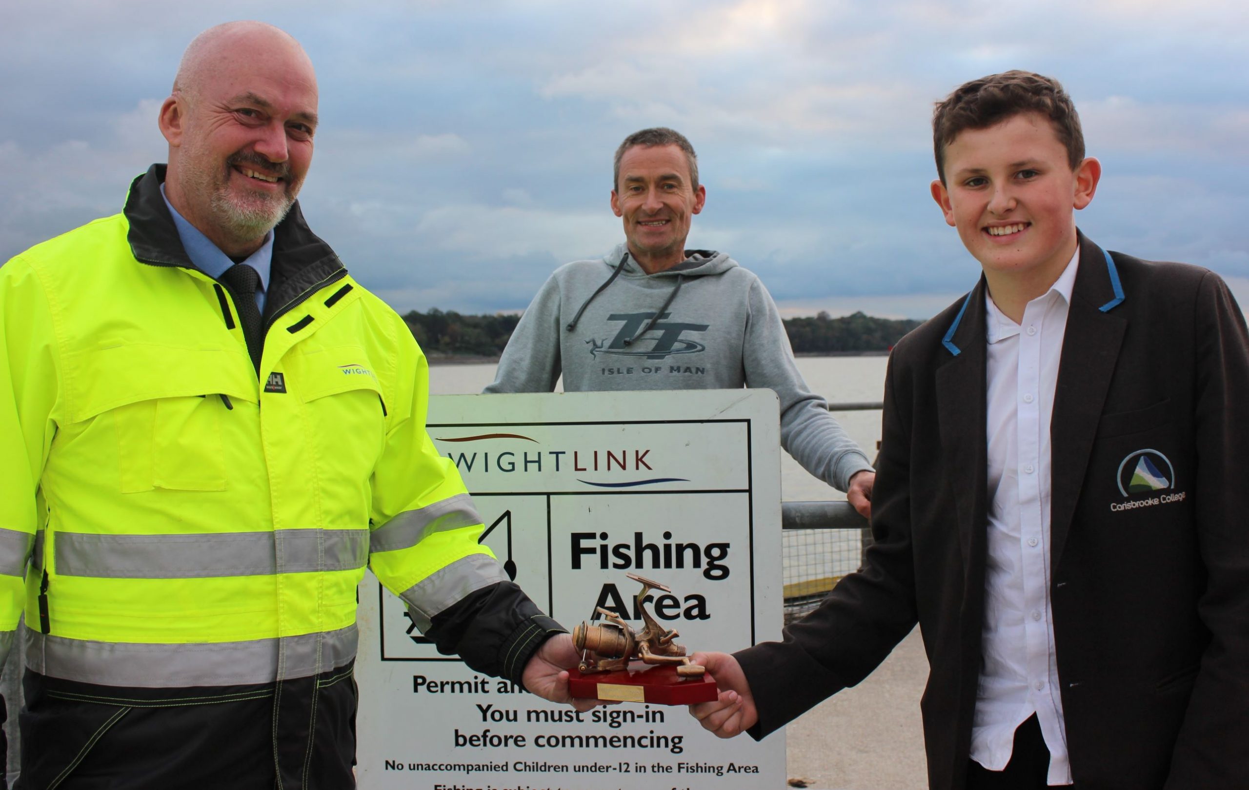 Twelve-year-old Tyler Thompson receiving an angling award from Wightlink