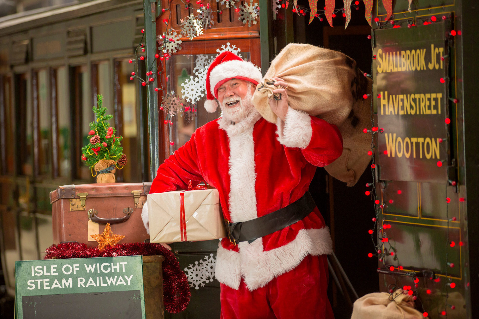 Santa holding presents at The Isle of Wight Steam Railway