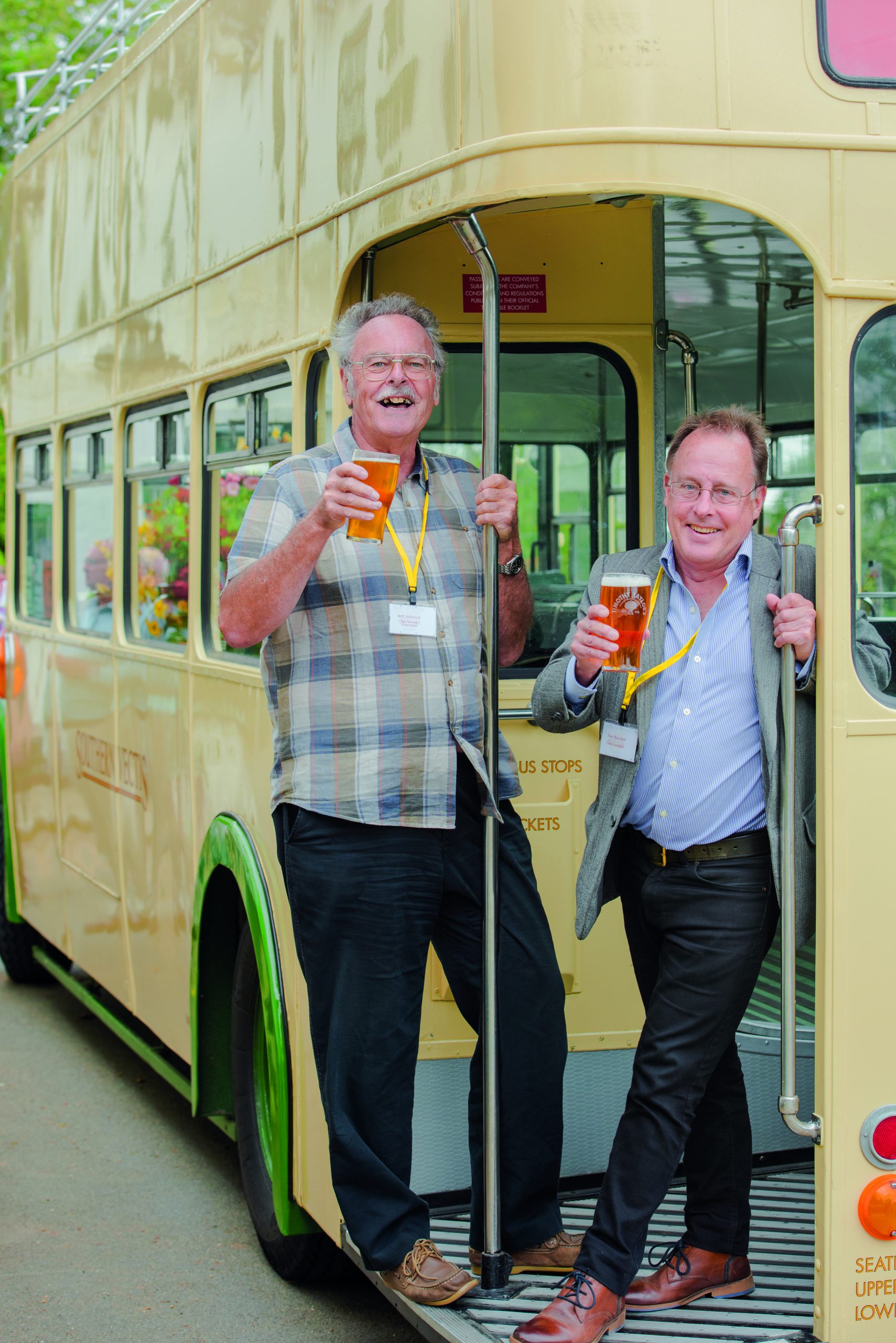 Bill Ackroyd and Tim Marshall on a bus holding beers on the Isle of Wight