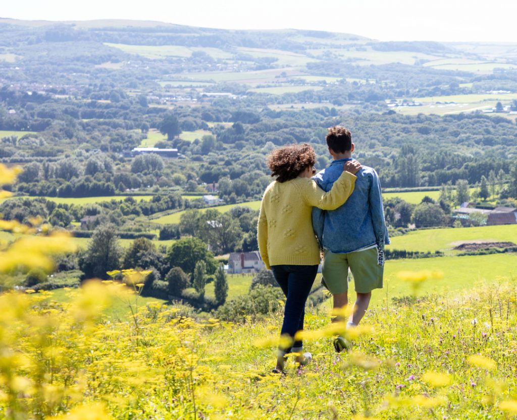 A couple walking in the Isle of Wight countryside in spring time