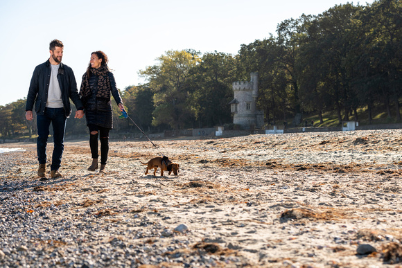 a couple walking on Appley Beach on the Isle of Wight with dog