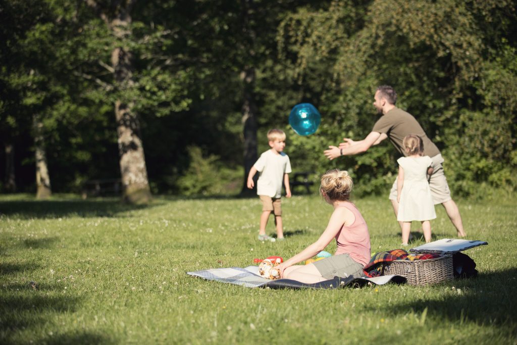 A family playing ball and having a picnic on the Isle of Wight