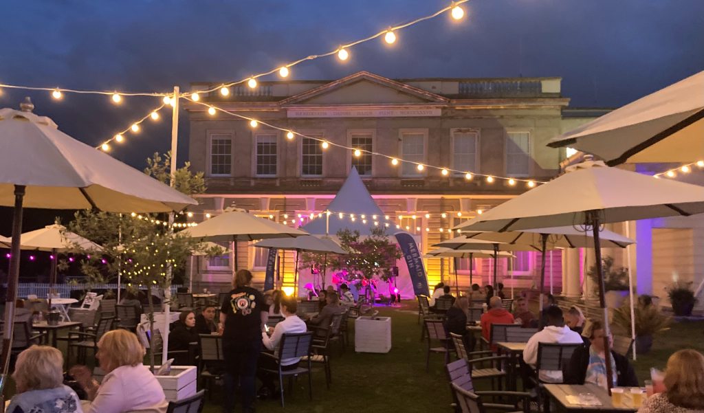 Fairy lights and tables outside at the Lawn Bar at Northwood House, Isle of Wight