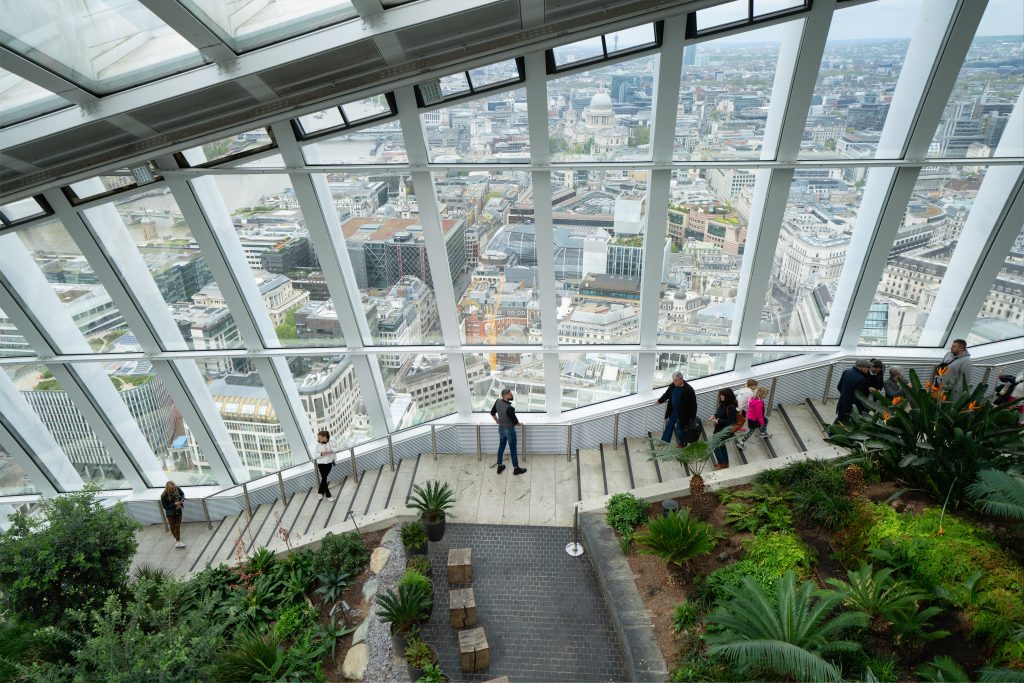 People walking down the stairs Sky Garden wth the city in the background (credit City of London Corporation Antoine Buchet)