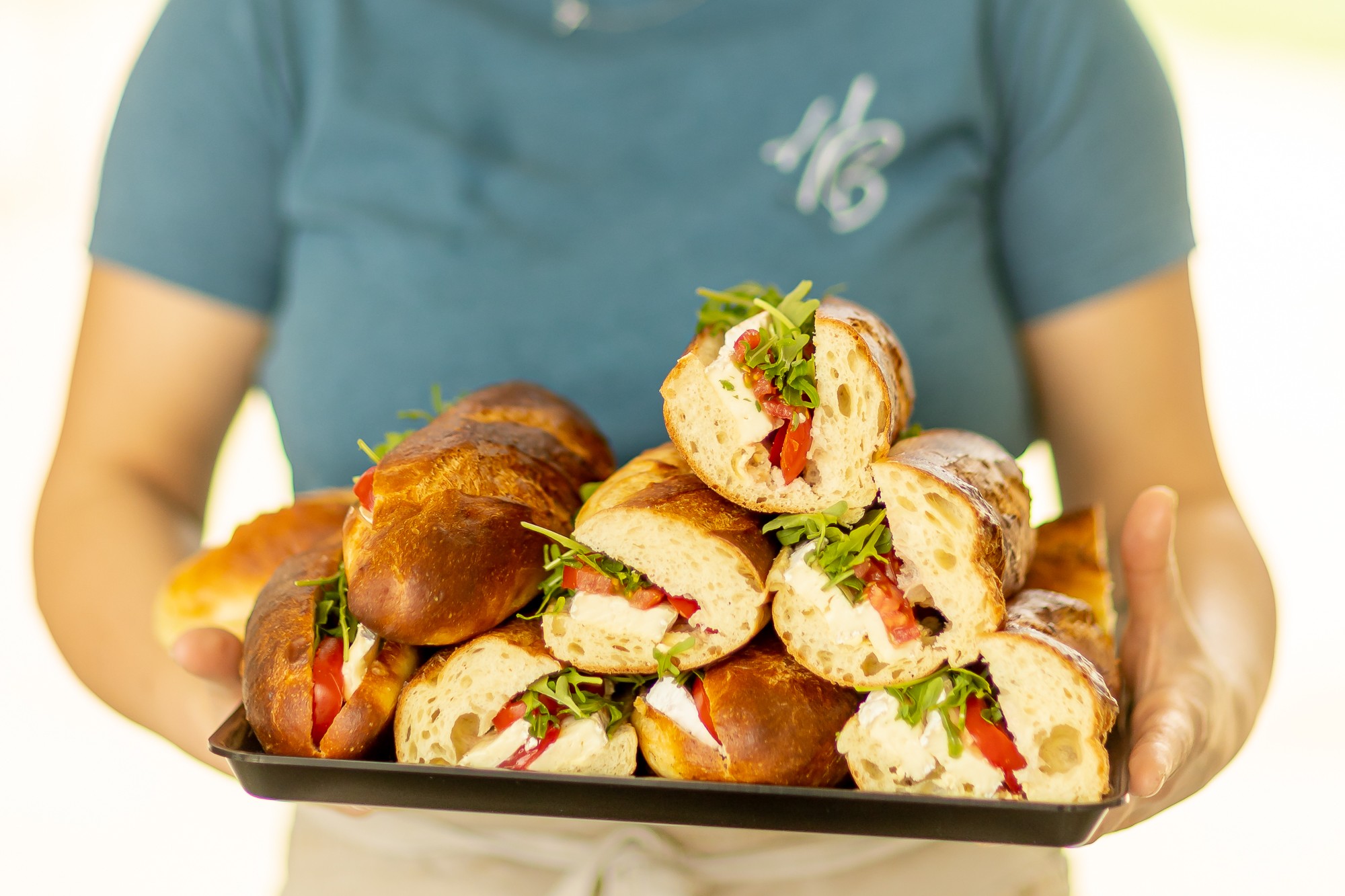 Freshly prepared baguettes filled with salad and cheese, served on a tray at Harvey Browns Kitchen.