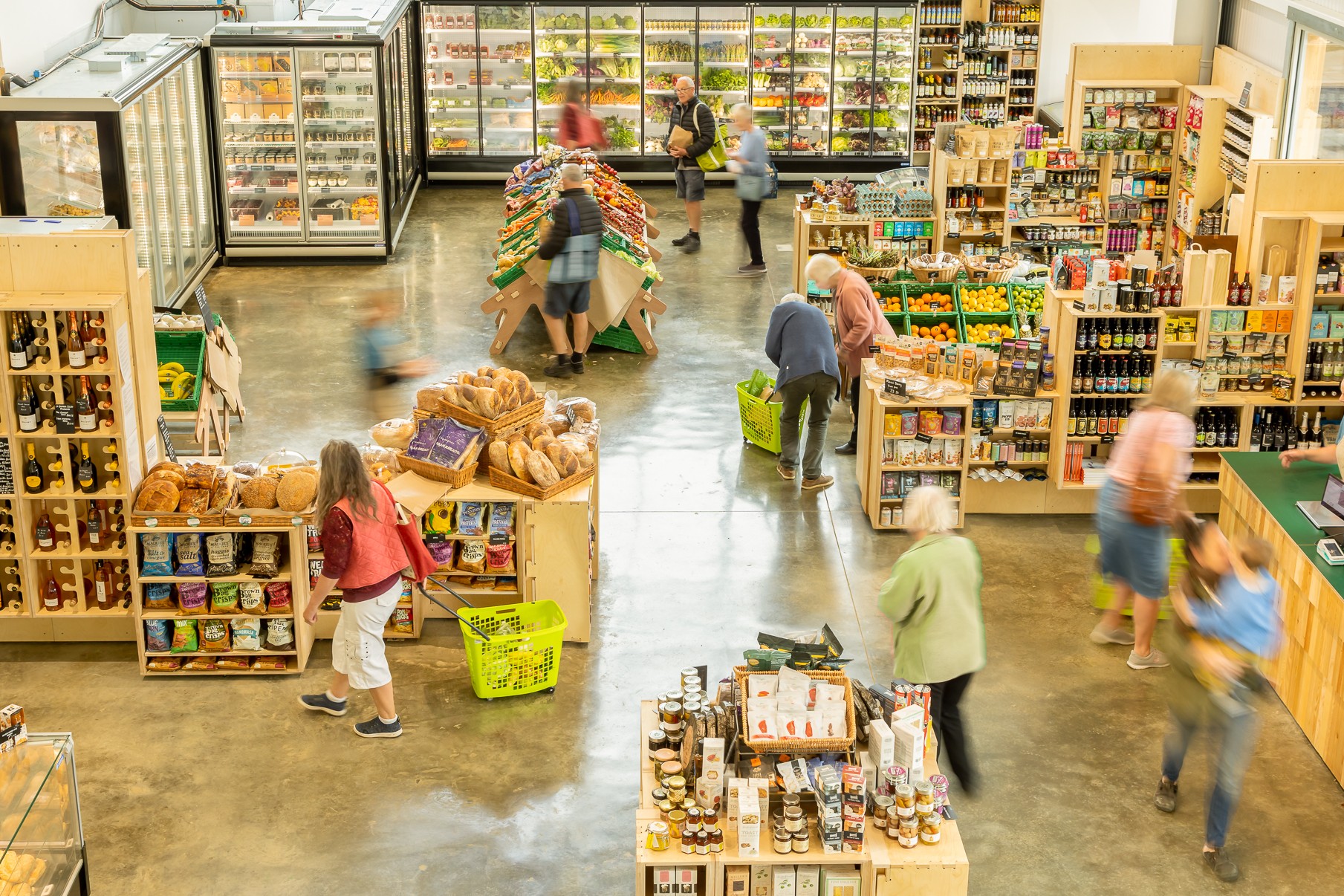 Shoppers browsing local produce, artisan foods and fresh groceries inside Harvey Browns Food Hall.