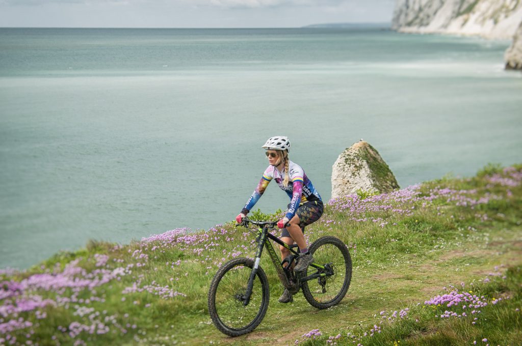 A female cyclist off road over Freshwater Bay