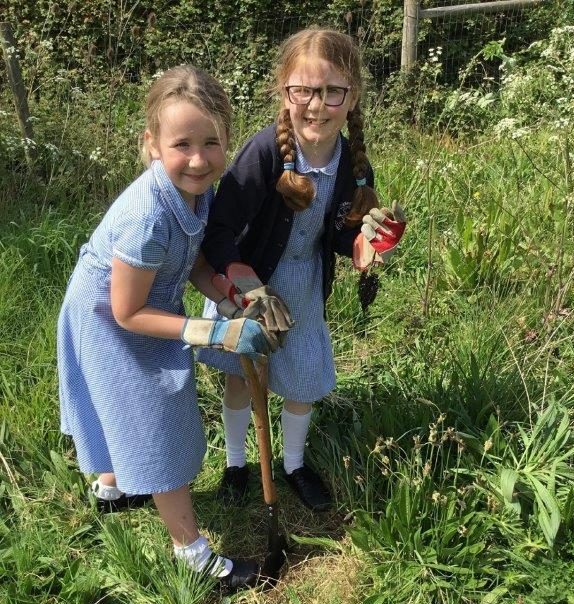 Two schoolchildren gardening at Brighstone School, Isle of Wight