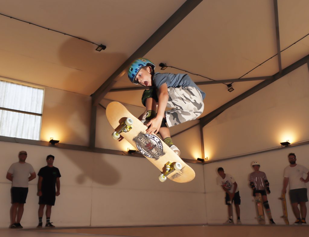 A young skateboarder doing a trick at an indoor skatepark - Canopy, Isle of Wight