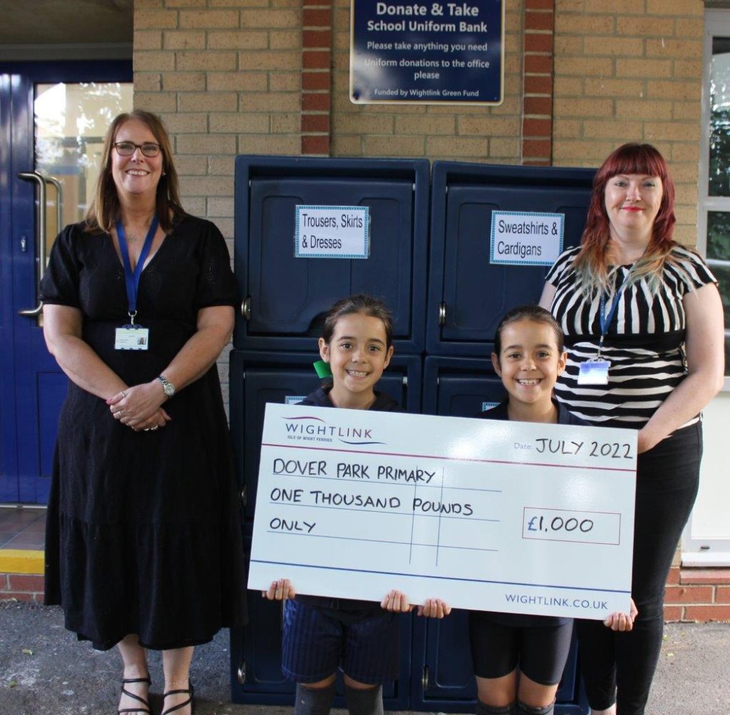 School pupils, a teacher and Wightlink employee with a giant grant cheque