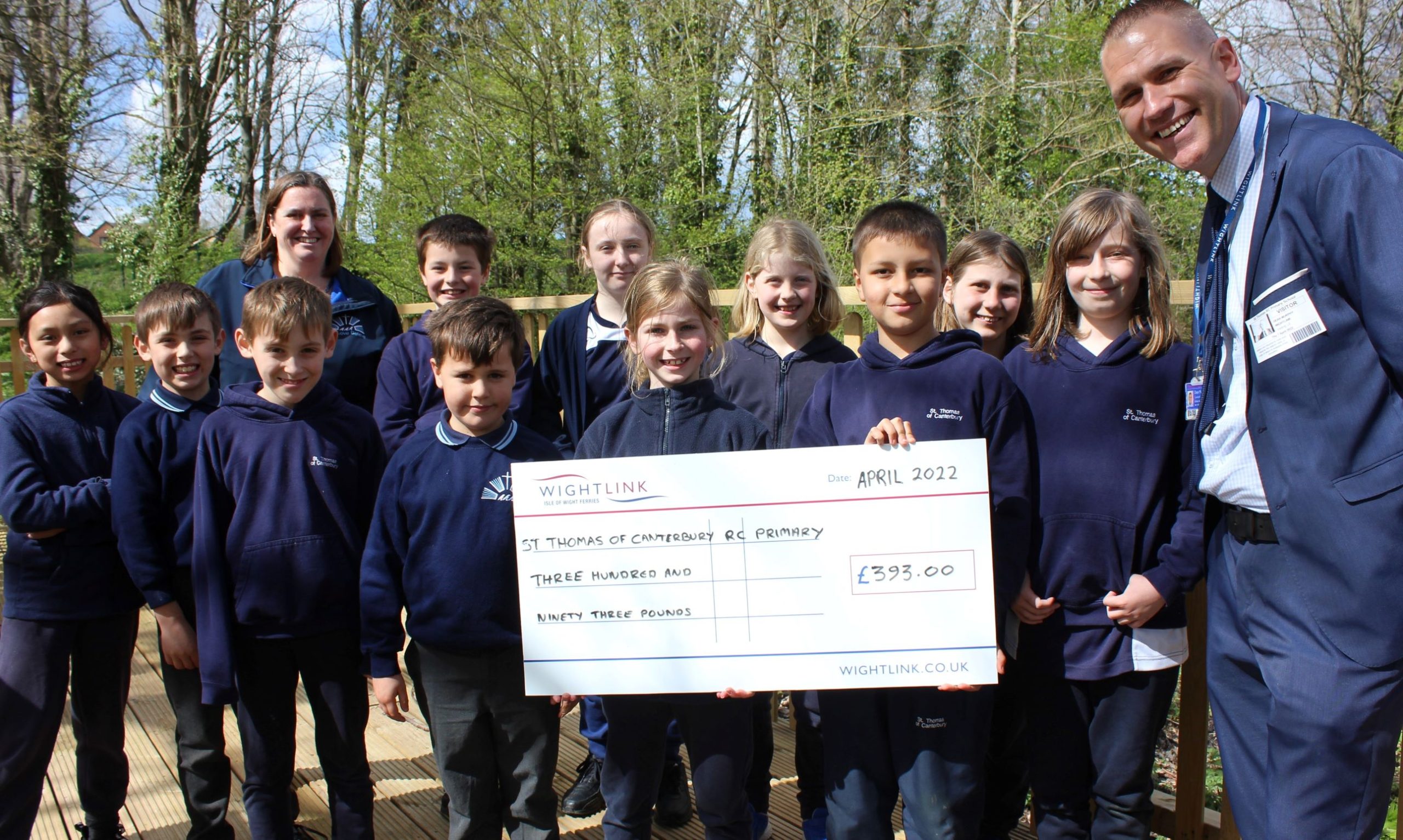 Pupils from St Thomas of Canterbury School on the Isle of Wight being presented with a giant grant cheque
