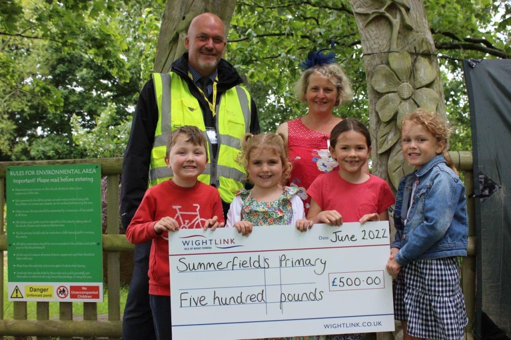 Wightlink staff presenting pupils and teacher from Summerfields Primary School with a giant cheque
