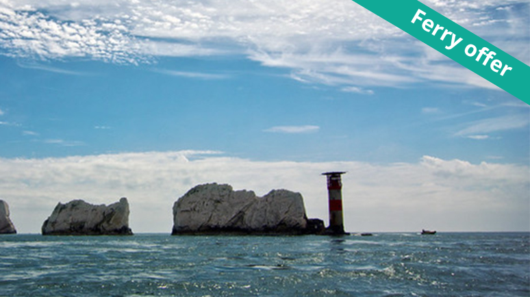 Blue ocean water and blue sky with thin white clouds with the famous Isle of Wight landmark The Needles. Banner across rop right corner reads 'Ferry Offer'.