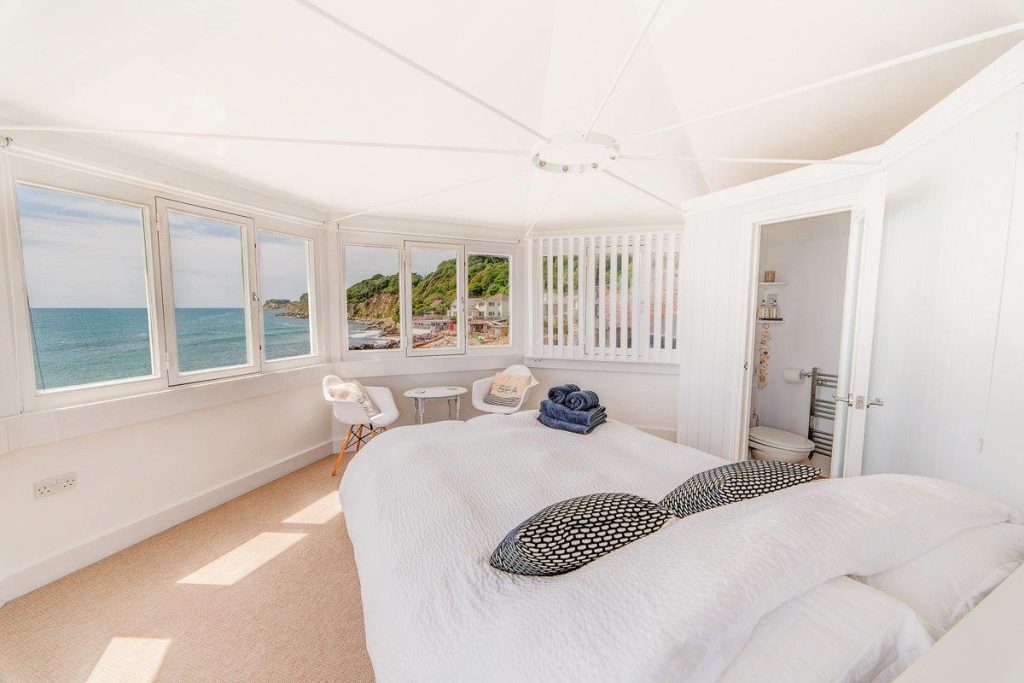 A bedroom in a holiday cottage overlooking the sea
