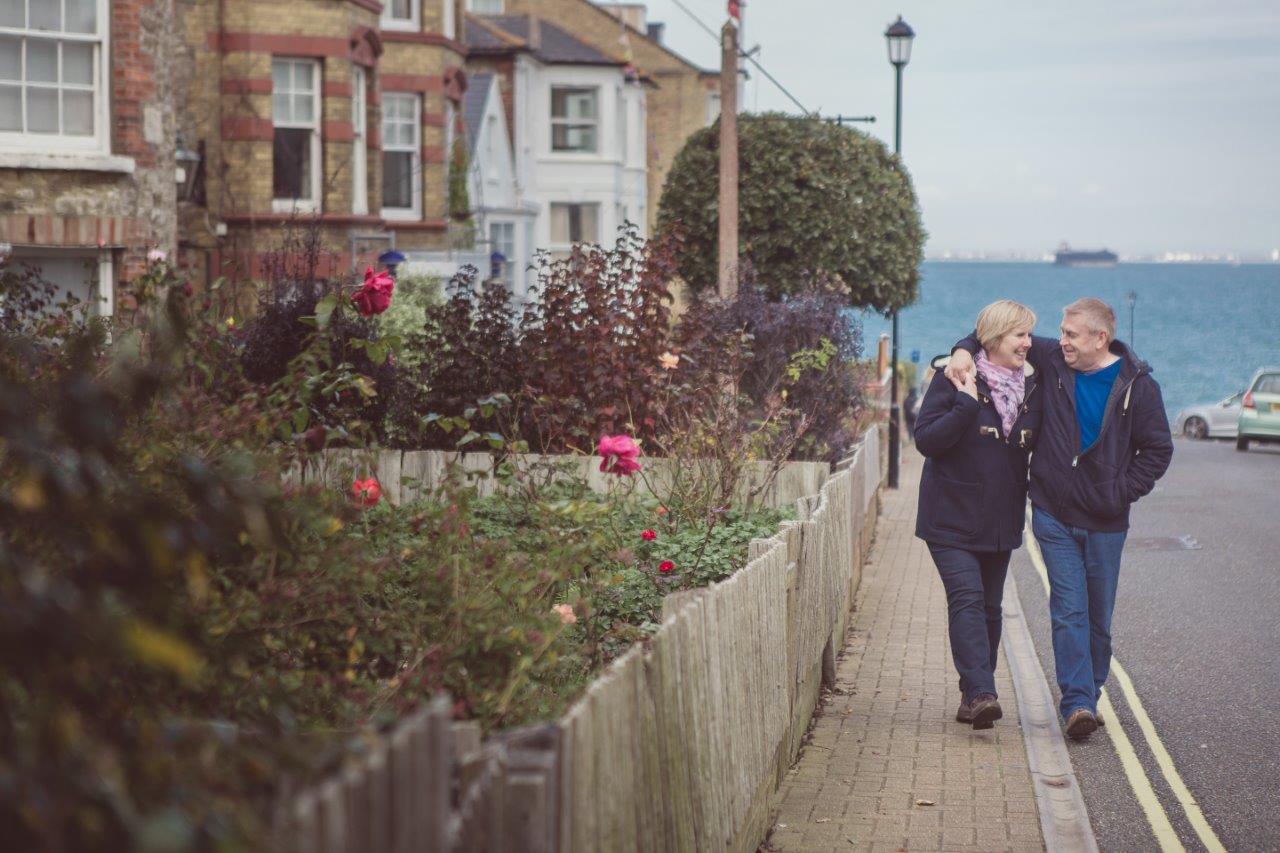 A couple walking on the pavement outside a hotel on the Isle of Wight