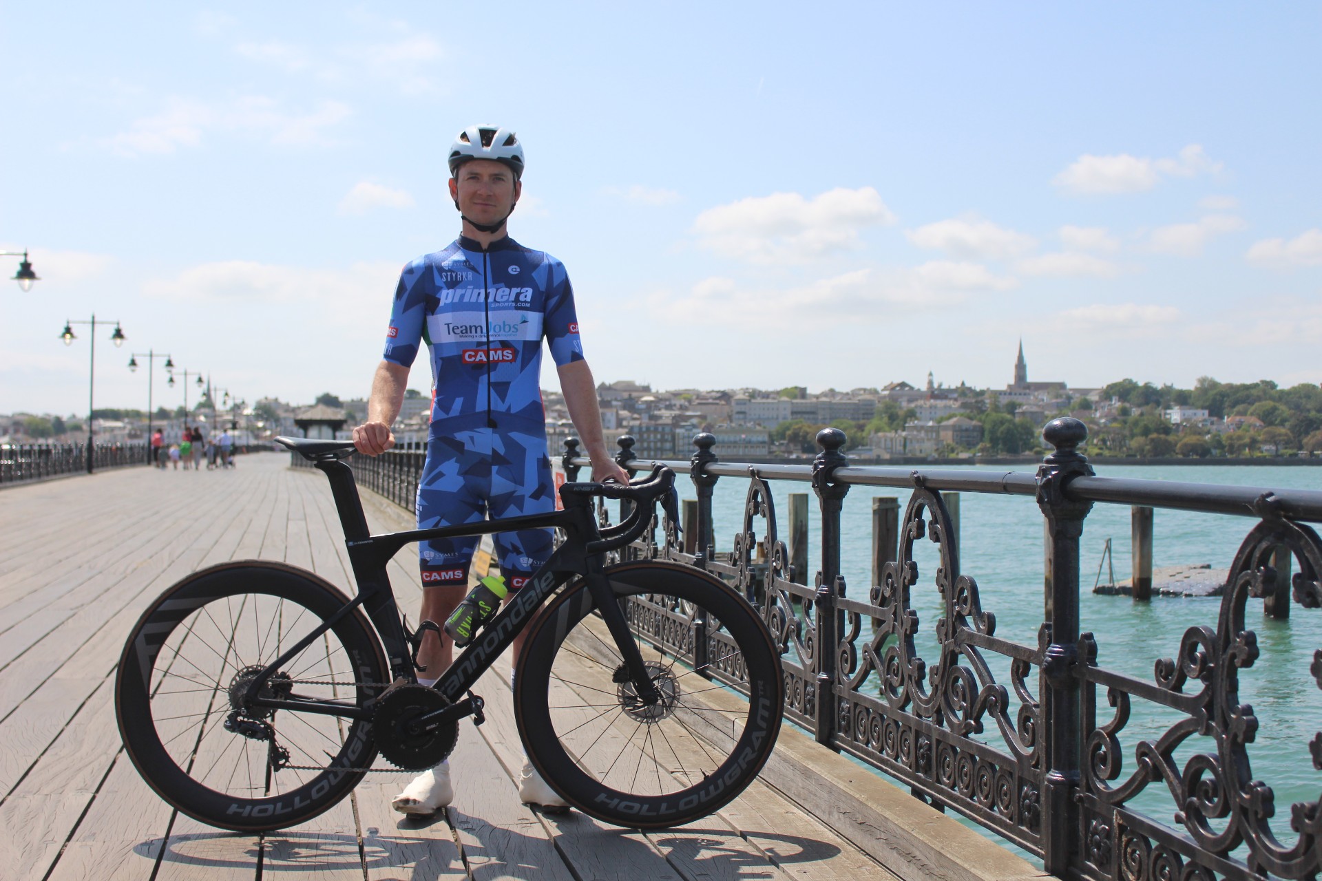 Cyclist Joe Staunton with his bike on Wightlink’s Ryde Pier, with Ryde in the background