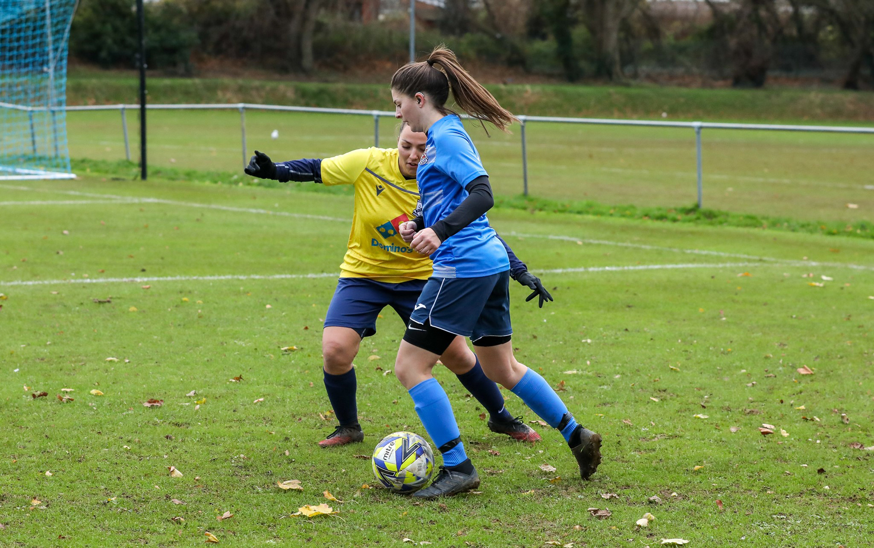 Footballer Lucy Scholes on the pitch, wearing a blue kit