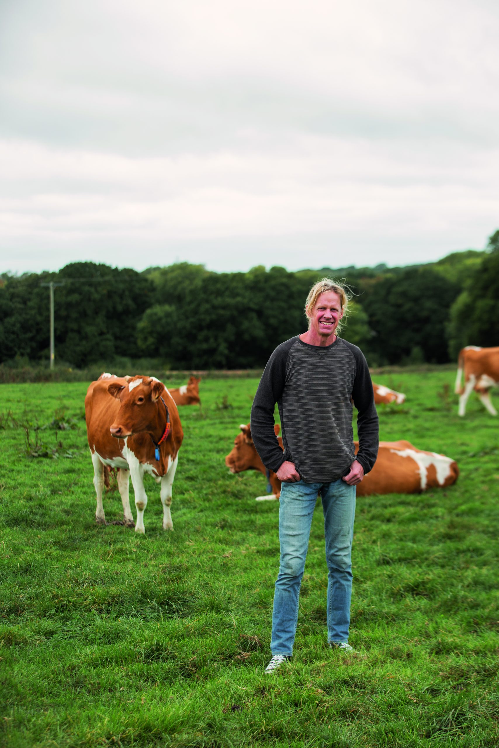 Paul from Briddlesford Farm standing in a field of cows