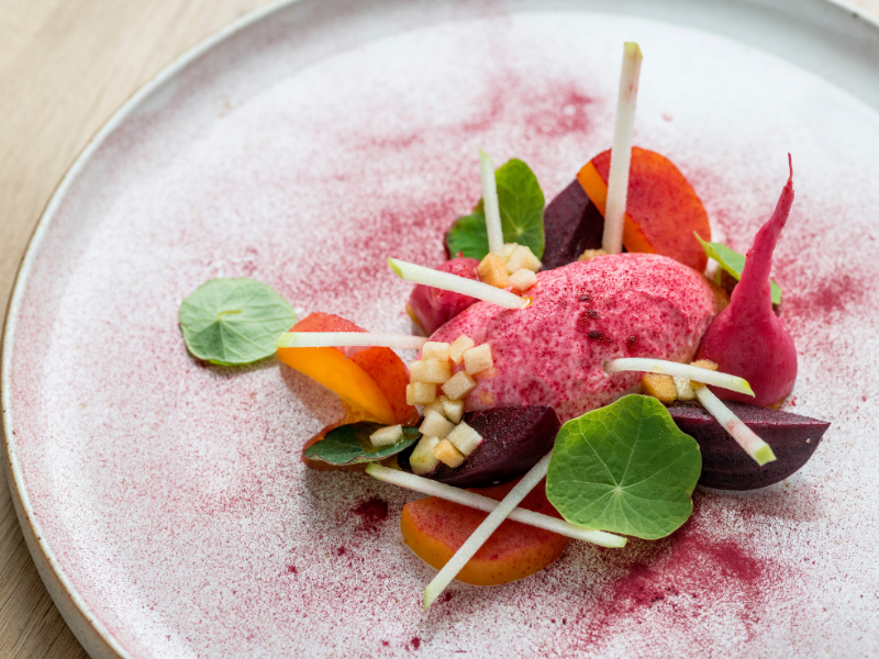 A white plate with artfully placed meal - the ingredients look fresh and brightly coloured