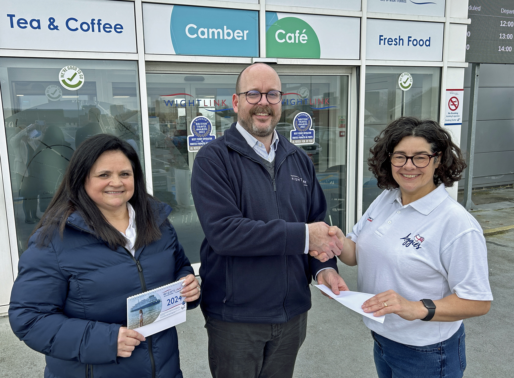 Kathryn Hearn receives the donation from Assistant Steward Annette Austin and Scott Rymer from Wightlink’s retail team