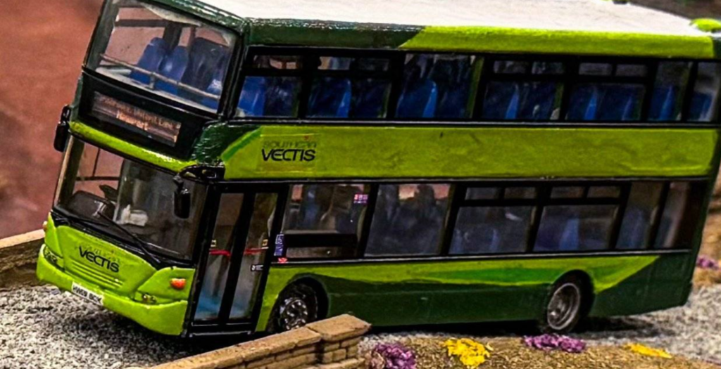A model of a bus. It's a green double decker and carries the brand of Southern Vectis