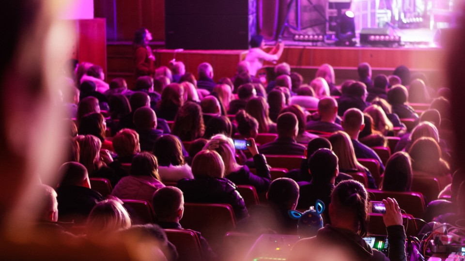 An audience watch on as a theatre show gets underway.