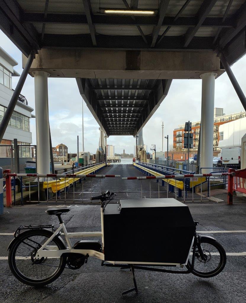 An e-cargo bike in front of a linkspan at a ferry company