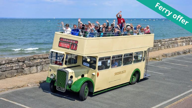 A group of people sitting on the top deck of a vintage bus waving. With a 'Ferry offer' banner in top right corner.