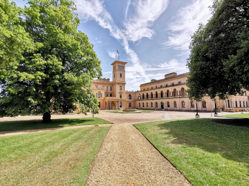 A stately palace, Osborne House, from a distance, showing approach and trees