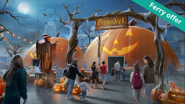 Families walking towards giant pumpkin-shaped domes at Pumpkinville, an immersive Halloween event, with glowing jack-o’-lanterns, spooky decorations and a sign overhead. A “Ferry offer” banner sits in the corner.