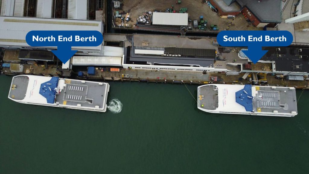 Aerial view of two Wightlink FastCat ferries docked side by side at Portsmouth Harbour, labelled with blue markers showing the 'North End Berth' and 'South End Berth'