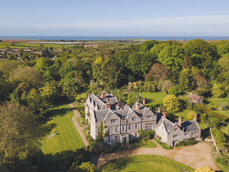 An aerial photo of a large manor house on the Isle of Wight, surrounded by countryside