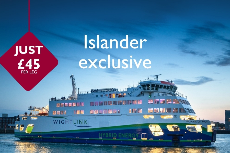 Wightlink’s hybrid ferry Victoria of Wight sailing at dusk with cabin lights glowing, overlaid with “Islander exclusive” and a red badge reading “Just £45 per leg.”