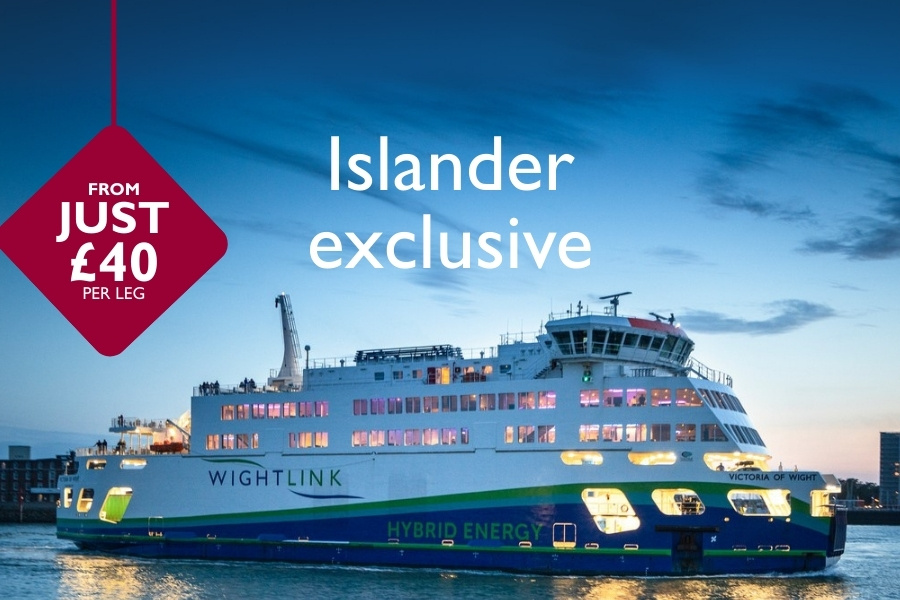 Wightlink’s hybrid ferry Victoria of Wight sailing at dusk with cabin lights glowing, overlaid with “Islander exclusive” and a red badge reading “From just £40 per leg.”