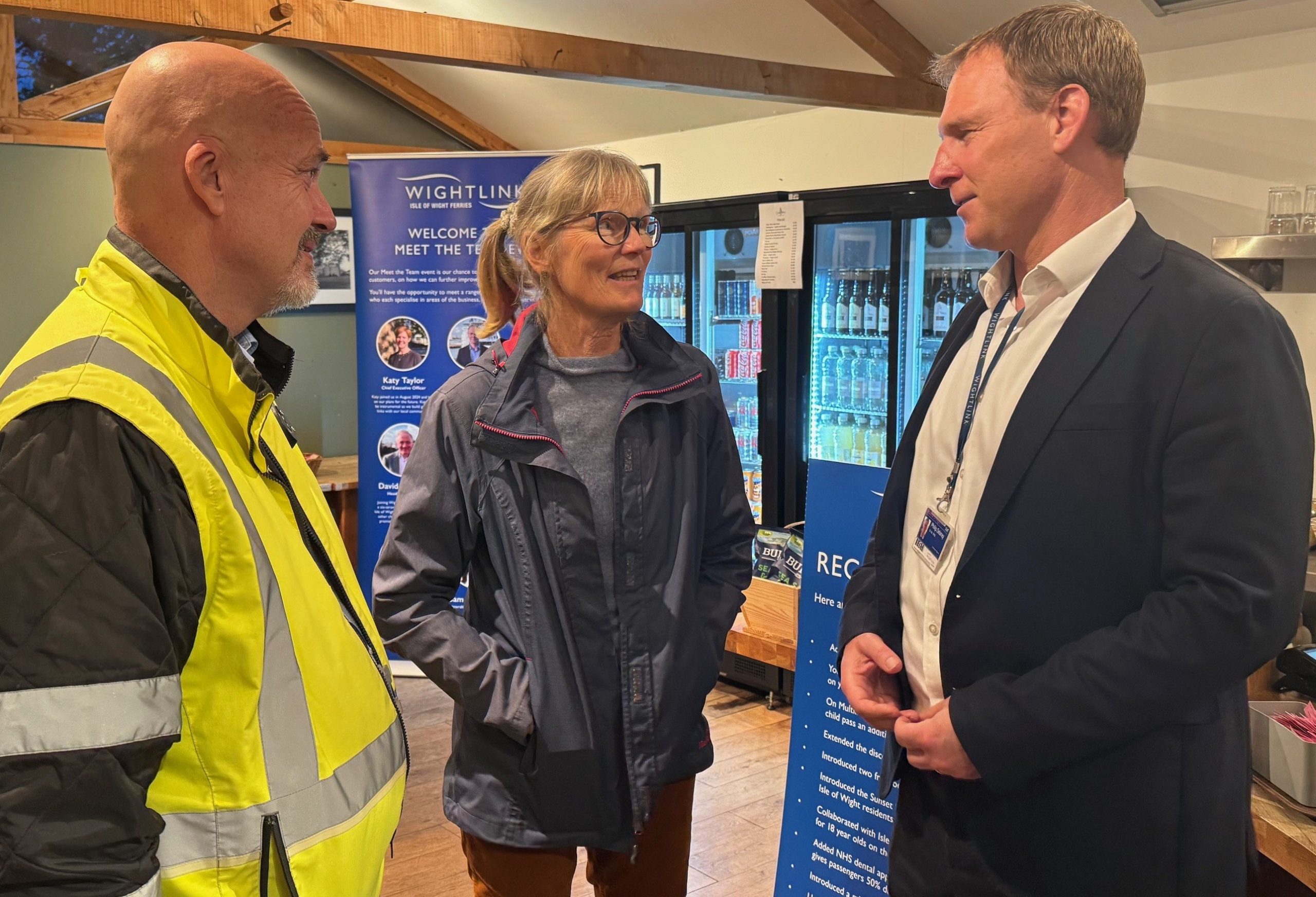 Three individuals in conversation.