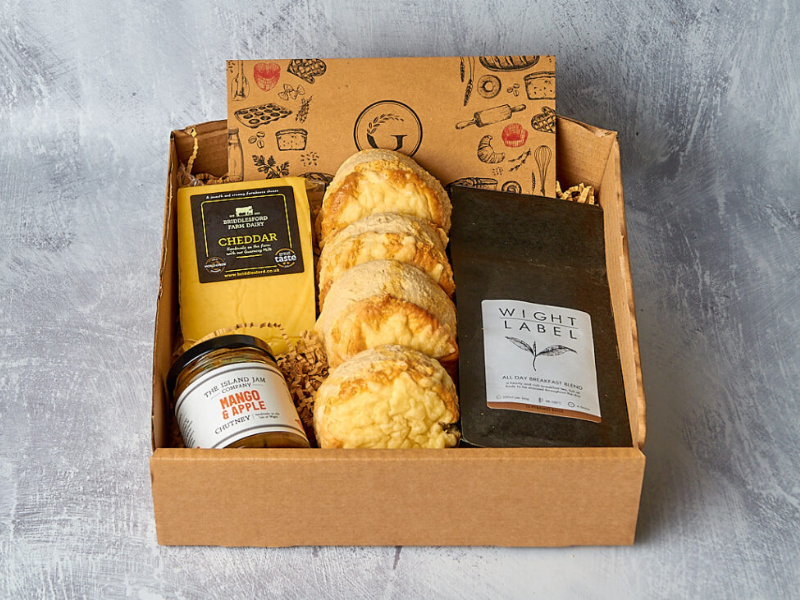 A giftbox hamper made up with scones, cheese, chutney and tea