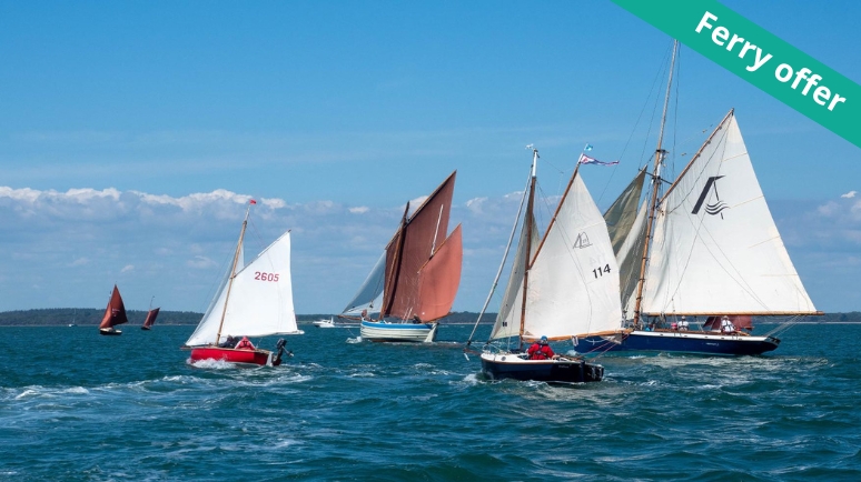four sailing boats under a blue sky in the Solent