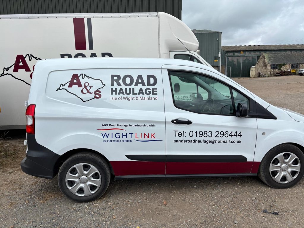 A small white van parked in a car park with A&S road haulage and Wightlink branding on the side.