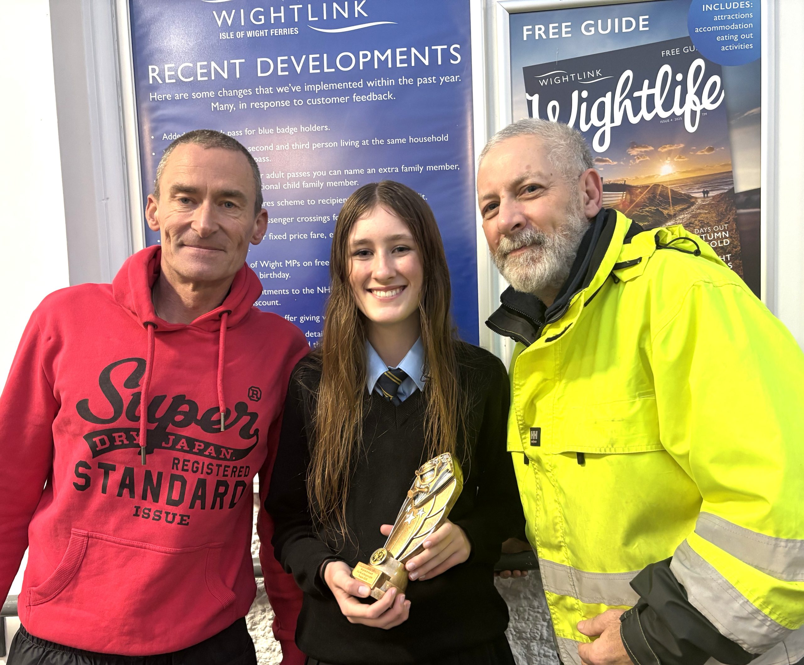 Picture caption: Sadie is pictured with Colin Webb, Fishing Frenzy organiser from Vectis Boating and Fishing Club (left) and Gary Watt, Wightlink Ryde Pier port operative.
