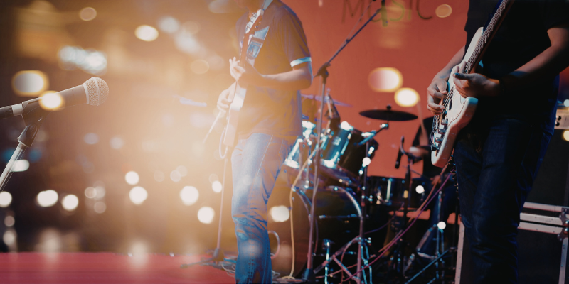 A band on stage with bright lights and instruments