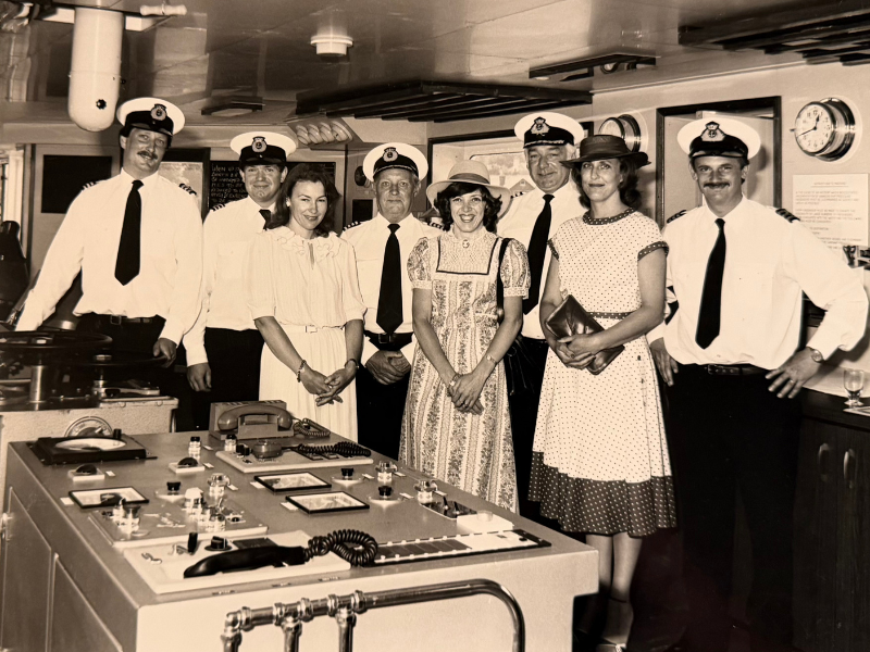 A black and white photo of Wightlink staff - captains and stewards - on the bridge of a ferry