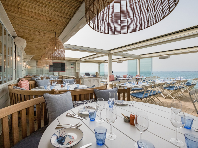 A table in an open air restaurant on the beach
