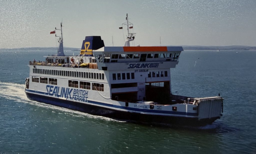 Sealink British Ferries vessel St Cecilia sailing in the Solent, showing white and blue livery with large branding and passengers visible on the open deck.