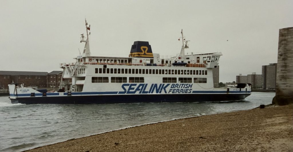 Sealink British Ferries vessel St Helen sailing past Portsmouth shoreline, showing white and blue livery with large “Sealink British Ferries” branding on the hull.
